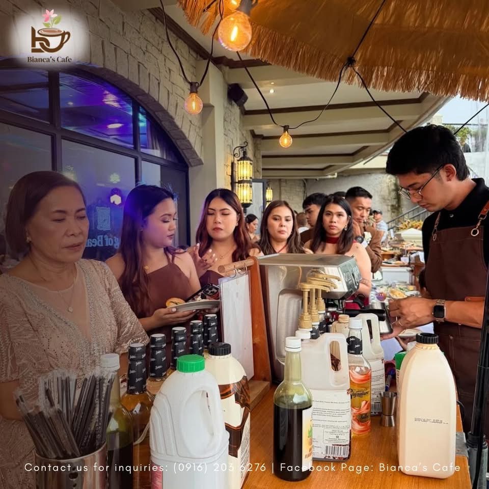 Guests gathering beside the Bianca’s Café coffee cart at an event