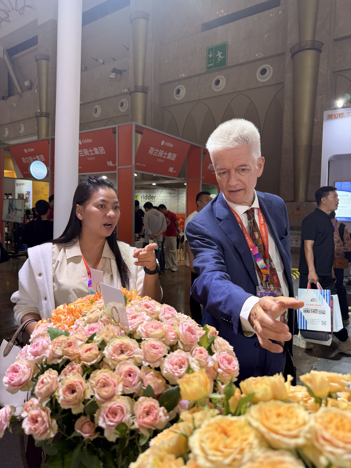 Viewing rose varieties displayed at a stand at IFEX